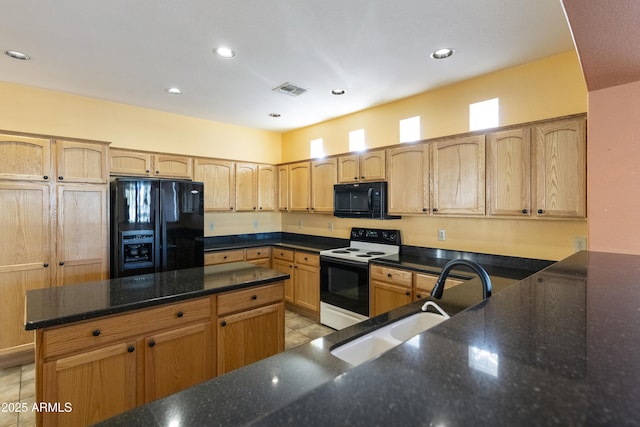 kitchen featuring black appliances, dark stone countertops, light brown cabinetry, sink, and light tile patterned floors