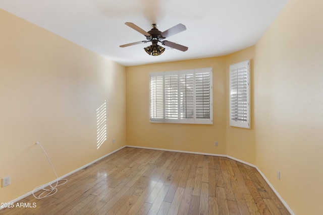 spare room featuring light hardwood / wood-style flooring and ceiling fan