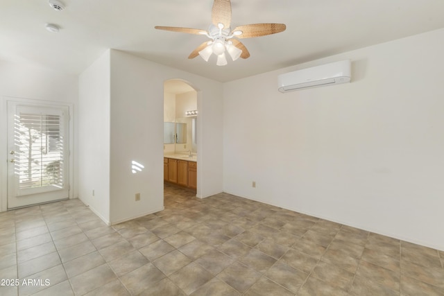 unfurnished room with ceiling fan and a wall mounted AC