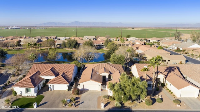 drone / aerial view with a water and mountain view