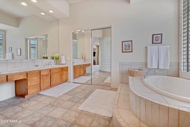 full bath featuring recessed lighting, a bath, and vanity