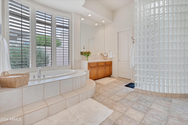 bathroom with vanity and a garden tub