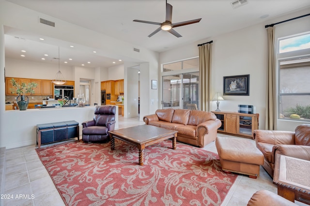 living room with recessed lighting, visible vents, and light tile patterned flooring