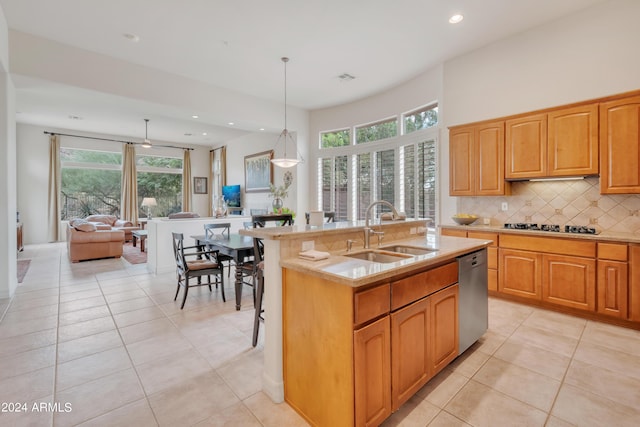 kitchen featuring light tile patterned flooring, backsplash, dishwasher, and a sink