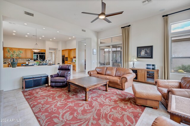 tiled living room with ceiling fan