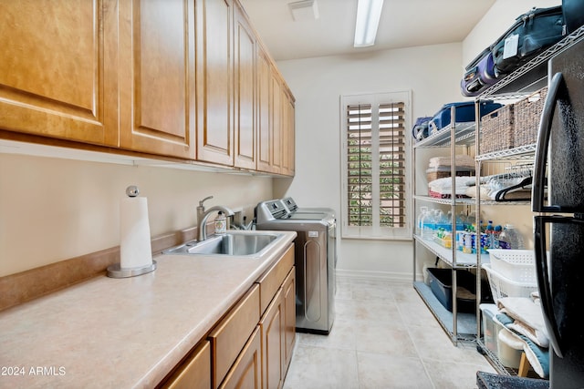 washroom with light tile patterned floors, visible vents, cabinet space, a sink, and washer and clothes dryer