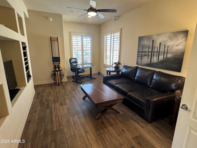 living room featuring dark wood-style floors, baseboards, and ceiling fan