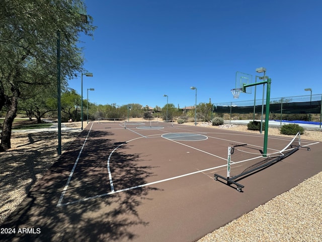 view of basketball court with community basketball court and fence