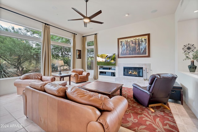 living area featuring a tiled fireplace, light tile patterned flooring, recessed lighting, and ceiling fan