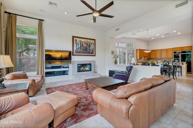 living area with visible vents, plenty of natural light, and a premium fireplace