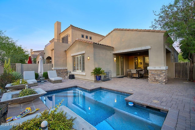 19475 N Grayhawk Dr # 1046, Scottsdale, AZ 85255 - rear view of house featuring stucco siding, a patio area, a chimney, and stone siding