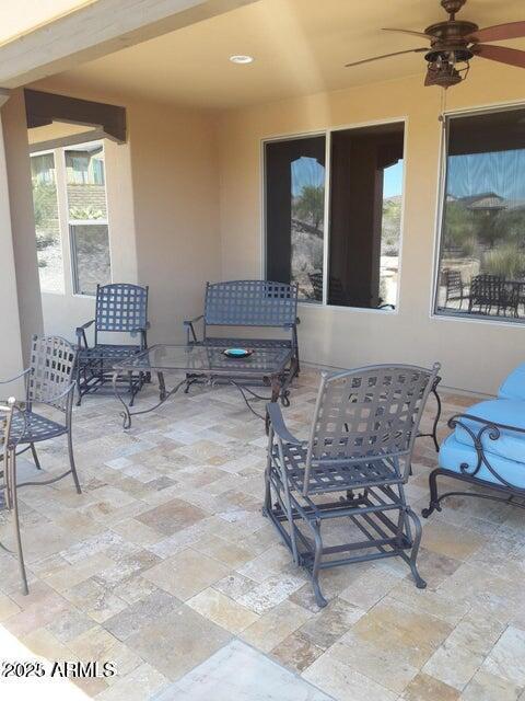 view of patio featuring a ceiling fan and outdoor dining area