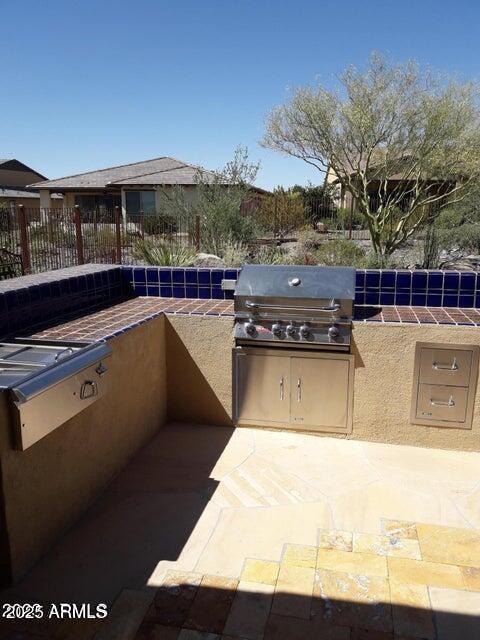 view of patio / terrace with fence and area for grilling