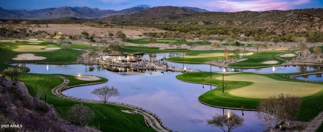 view of property's community with view of golf course and a water and mountain view