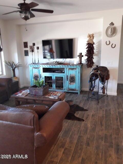 living room with wood finished floors and a ceiling fan