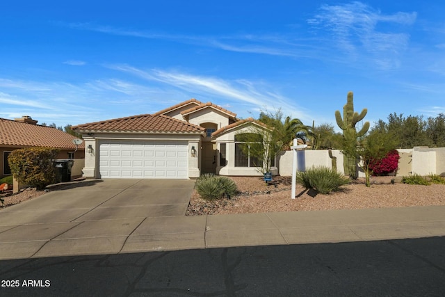 mediterranean / spanish home with a garage, fence, a tiled roof, driveway, and stucco siding