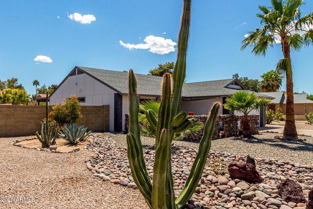 5601 W Whitten St, Chandler, AZ 85226 - view of home's exterior with an attached garage, board and batten siding, and fence