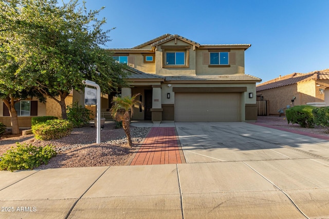 6632 W Saguaro Park Ln, Glendale, AZ 85310 - view of front of house featuring stucco siding, driveway, a garage, and a tile roof