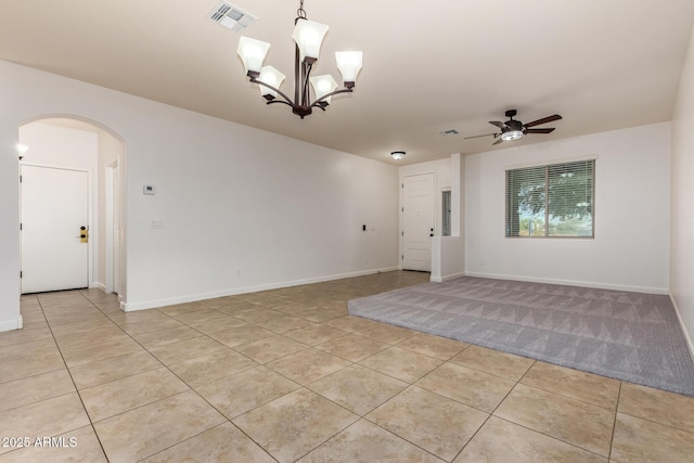 6632 W Saguaro Park Ln, Glendale, AZ 85310 - spare room featuring arched walkways, light tile patterned flooring, ceiling fan, and baseboards