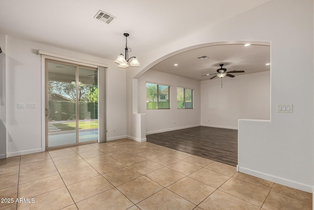 6632 W Saguaro Park Ln, Glendale, AZ 85310 - unfurnished room featuring light tile patterned flooring, ceiling fan, arched walkways, recessed lighting, and baseboards