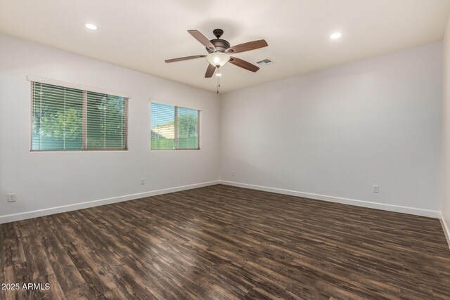 6632 W Saguaro Park Ln, Glendale, AZ 85310 - empty room with dark wood finished floors, a ceiling fan, baseboards, and recessed lighting