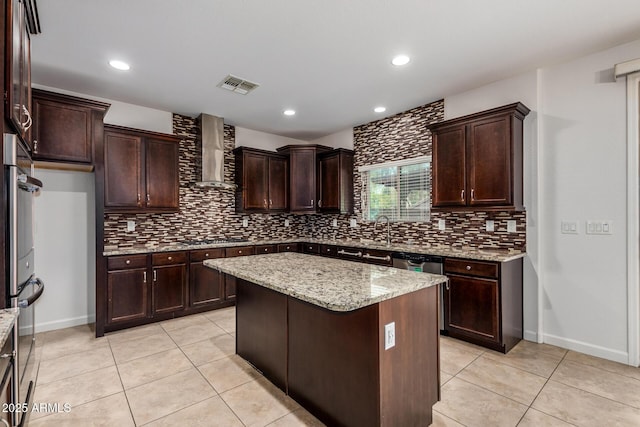 6632 W Saguaro Park Ln, Glendale, AZ 85310 - kitchen featuring wall chimney exhaust hood, tasteful backsplash, light tile patterned flooring, and recessed lighting