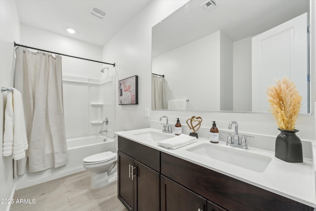 bathroom with shower / bath combination with curtain, visible vents, and a sink