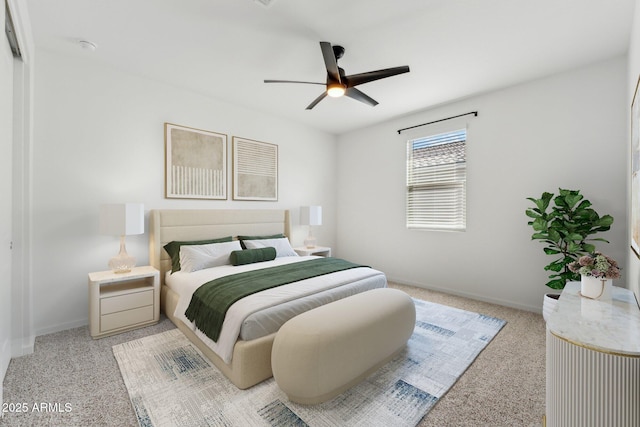 bedroom with a ceiling fan and baseboards