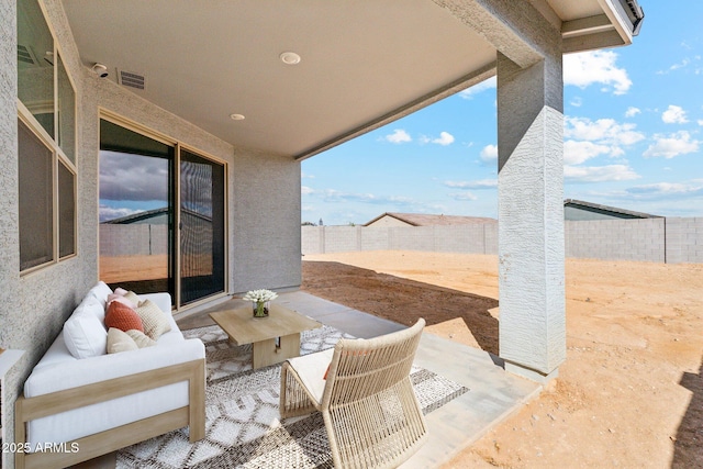 view of patio featuring a fenced backyard, visible vents, and an outdoor living space