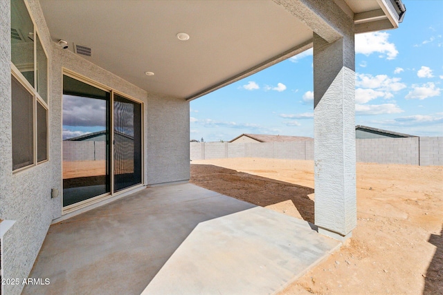 view of patio with a fenced backyard and visible vents