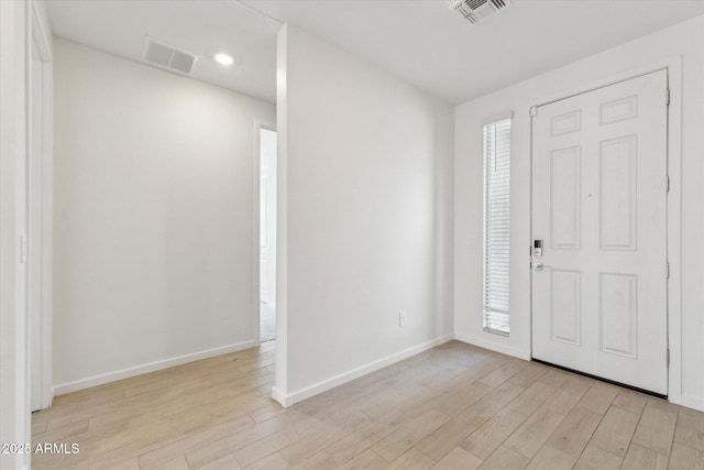 entrance foyer with light wood-type flooring, visible vents, and baseboards