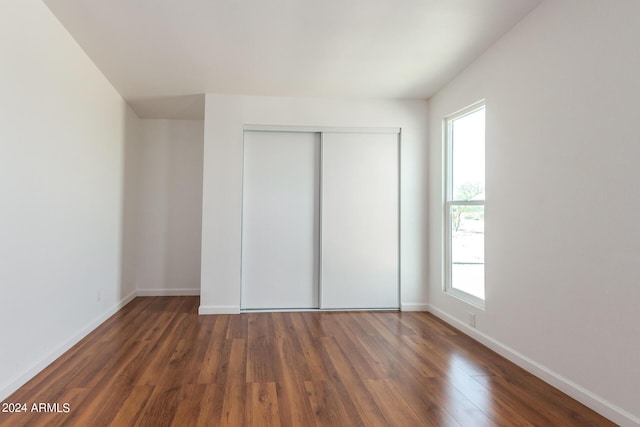 50858 W Bitter Root Rd, Maricopa, AZ 85139 - unfurnished bedroom with a closet, wood finished floors, and baseboards