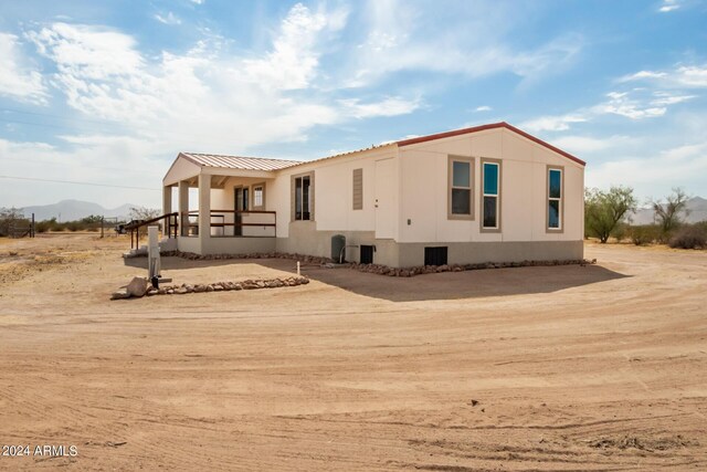 50858 W Bitter Root Rd, Maricopa, AZ 85139 - view of front of home with a mountain view and metal roof