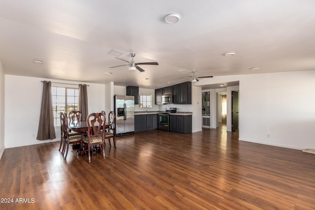 50858 W Bitter Root Rd, Maricopa, AZ 85139 - dining area featuring dark wood-style flooring, baseboards, vaulted ceiling, a ceiling fan, and visible vents