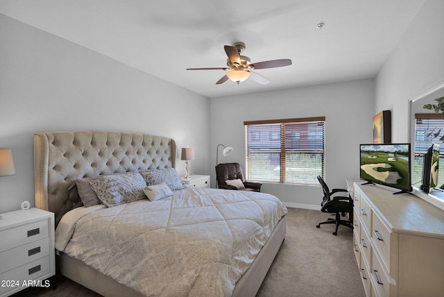 bedroom featuring a ceiling fan, light carpet, and baseboards