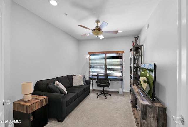 home office with light carpet, ceiling fan, and baseboards