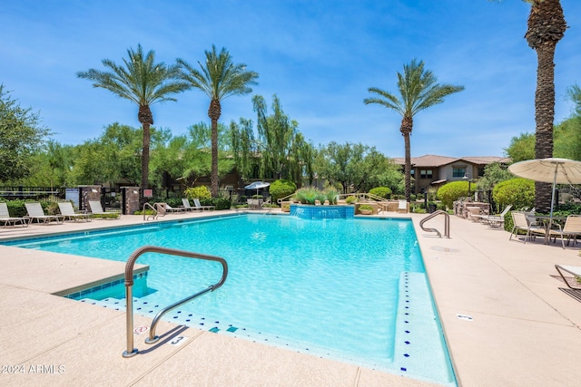 pool featuring a patio area and fence