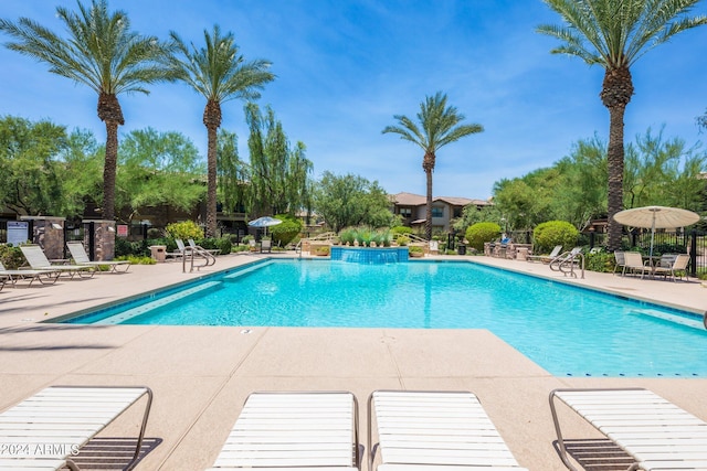 pool with fence and a patio