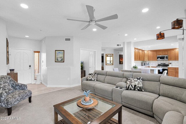 living room with ceiling fan and light wood-type flooring