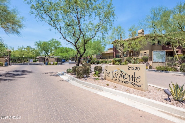 community / neighborhood sign featuring a gate