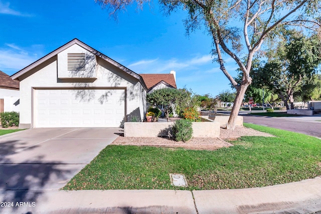 view of front of property with a front yard and a garage