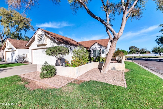 view of front of property with a garage and a front yard