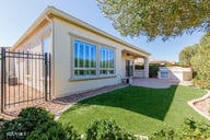 back of house with fence, a patio, and a lawn