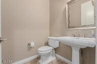 bathroom with toilet and baseboards