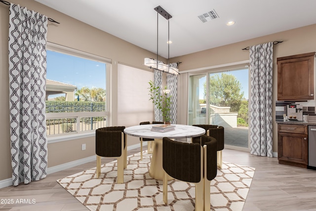 dining room featuring recessed lighting, a healthy amount of sunlight, baseboards, and an inviting chandelier