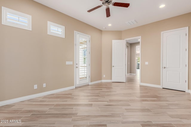 empty room with light wood-style flooring, visible vents, baseboards, and recessed lighting