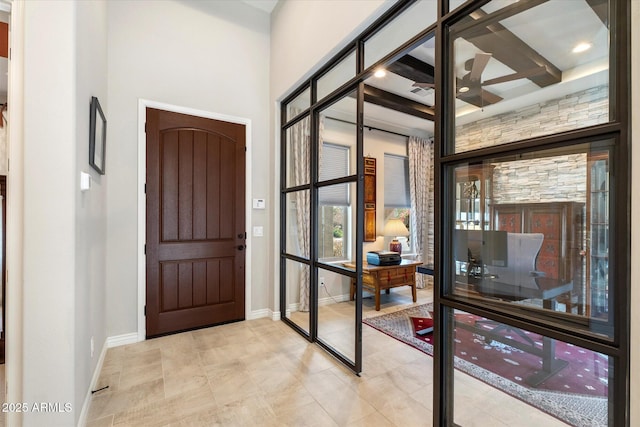 entrance foyer with baseboards and a ceiling fan