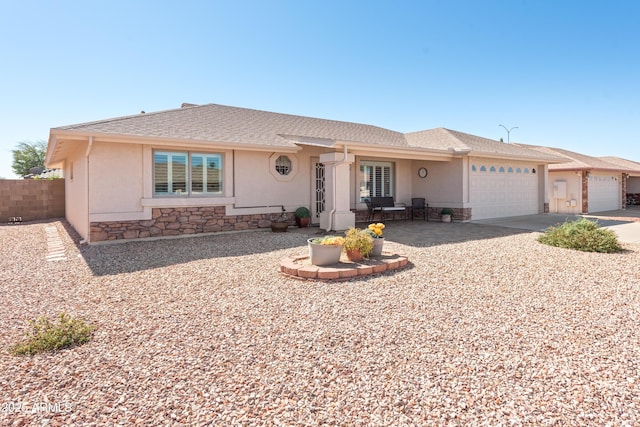 ranch-style home featuring stone siding, fence, an attached garage, and stucco siding