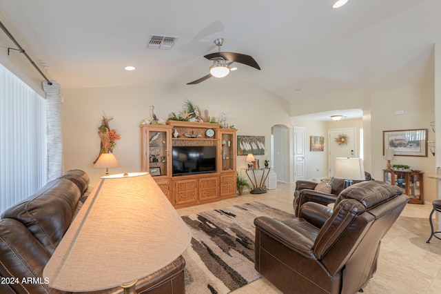 living room featuring ceiling fan, a healthy amount of sunlight, and vaulted ceiling