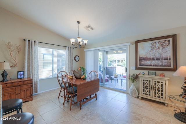 tiled dining area featuring lofted ceiling, plenty of natural light, and a notable chandelier